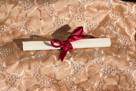 Scroll tied up by a red tape with a bowの写真素材