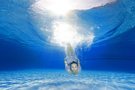 athletic girl diving in the swimming poolの写真素材