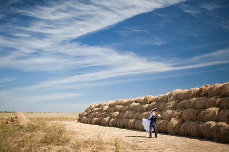 couple in the field with hayの写真素材