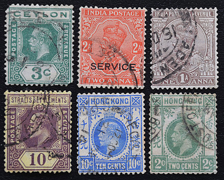 A series of old postage stamps of English colonies.