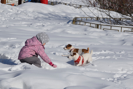 Children with parents rest in a snow park in early spring. Western Siberia, March 3, 2017.のeditorial素材