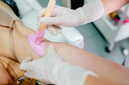 Waxing armpit hair, pink wax close upの写真素材
