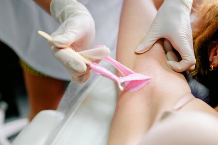 Waxing armpit hair, pink wax close upの写真素材
