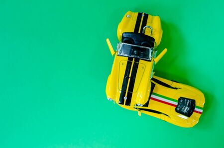 Photo of a miniature GAZ-12 ZIM car. Retro car rides through the city on a winter night. Snowing. Childrens toy. Creative, realistic picture.の写真素材