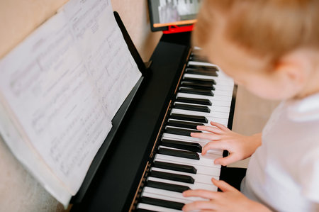 Pretty young musician playing classic digital piano at home during online class at home