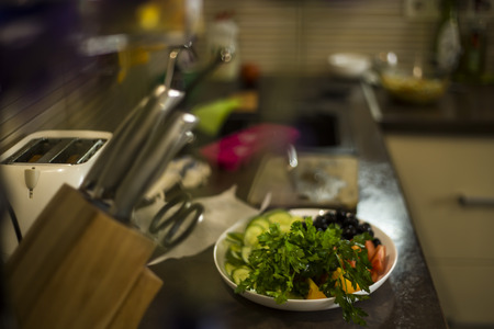Preparation of a vegetable plate for a family dinner in a home kitchenの写真素材