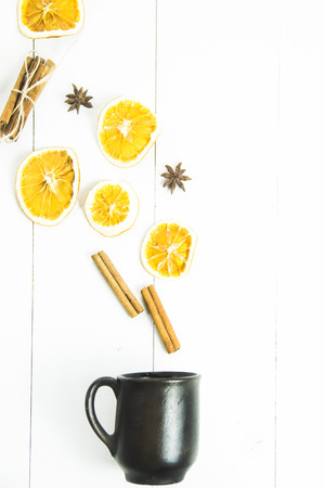 ingredients of spices and oranges for mulled wine are poured from a clay cupの写真素材