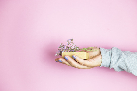 Natural soap with sprigs of natural flowers in female handsの写真素材