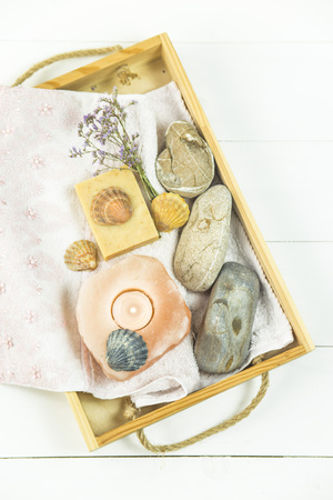 wooden tray with accessories for spa procedures with a floppy, candles and soap. Flat lay. Top viewの写真素材