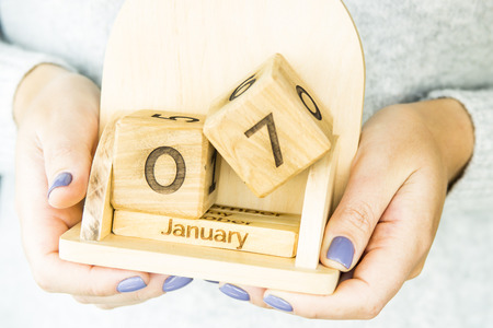 woman holding a wooden calendar with the date of Orthodox Christmas January 7の写真素材