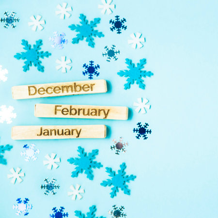 inscriptions of the names of the months on wooden plates - December, January, February, on a blue...