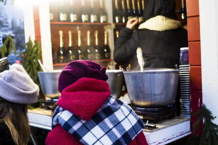 Girls buying mulled wine at the Christmas marketの写真素材