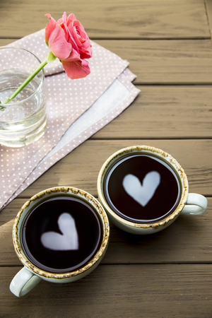 Two hearts are reflected in two cups of coffee. Valentine's Day Conceptの写真素材