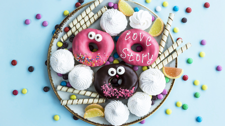 Sweet unhealthy food on a plate - donuts, meringue, sticks, marmalade, chocolate grains. Junk food conceptの写真素材