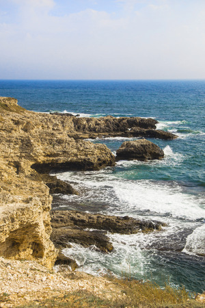 The sea landscape of Cape Tarkhankut, Crimea peninsula. Blue water and yellow rocks. Bright sunny background or wallpaperの写真素材