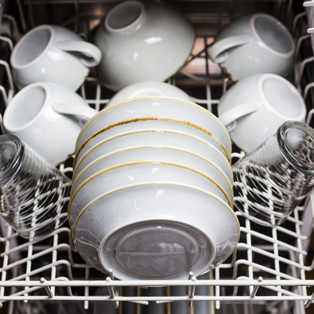 Clean dishes and cups in the dishwasher. Home equipment. Blue Rustic Tablewareの写真素材