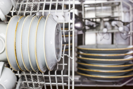Clean dishes and other cutlery in the dishwasher. Home equipment. Blue Rustic Tablewareの写真素材