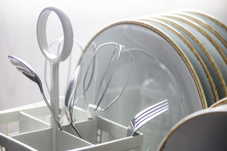 Clean dishes and cutlery in the dishwasher. Home equipment. Blue Rustic Tablewareの写真素材