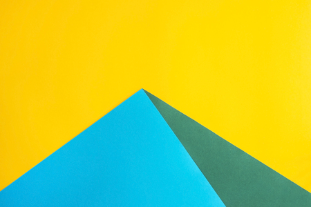 Combined multicolored decorative background In the form of a pyramid. The main color is yellow and additional - green and blue. Copyspace, flat lay, top viewの写真素材