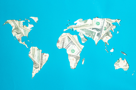 World map. Continents are laid out of dollars. Capitalism, consumer society conceptの写真素材