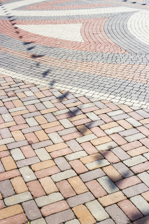 Reflection of triangular decorative flags on the paving slab. Shadowの写真素材