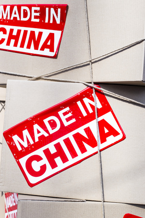 Cardboard boxes with red inscription Made in China. Production of goods for sale conceptの写真素材