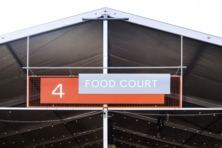 Food court - a large sign above the canopy of a place to feed on open air. Summer entertainment, festivalの写真素材