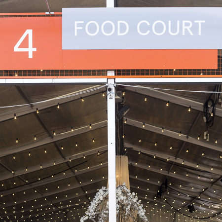 Food court - a large sign above the canopy of a place to feed on open air. Summer entertainment, festivalの写真素材