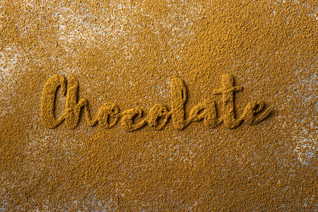 The word chocolate is lined with beautiful cocoa letters on the background of cocoa powder. I love chocolate conceptの写真素材