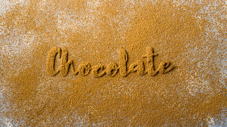 The word chocolate is lined with beautiful cocoa letters on the background of cocoa powder. I love chocolate conceptの写真素材