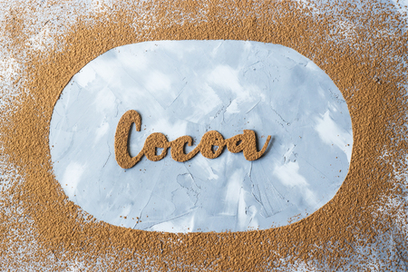 The word cocoa is written in letters of cocoa on a gray background in the oval of cocoa powder. I love the cocoa conceptの写真素材