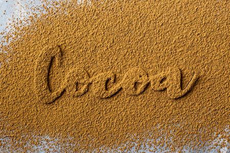 The word cocoa is written on the background of cocoa powder. I love the cocoa concept. Ingredient for chocolateの写真素材