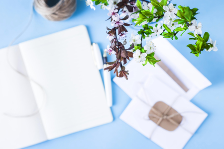 A bouquet of spring twigs in the workplace with a notebook on a blue background.
Spring workplace concept. Blurred imageの写真素材