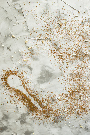 A spoonful of cocoa on a gray background. Dessert food concept. Copyspaceの写真素材