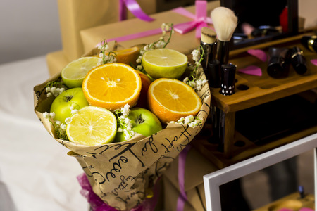 Fruit bouquet with oranges, apples and flowersの写真素材