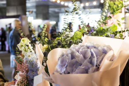 Beautiful diverse bouquets with eucalyptus on the flower market in the loft with lanternsの写真素材