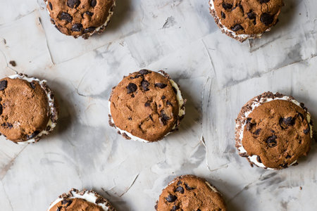 Sandwich ice cream with chocolate cookies on a gray background. Summer dessert concept. Top view,...