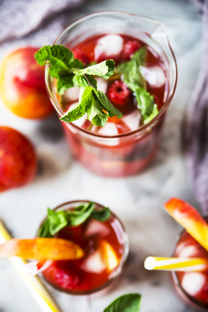 Light summer refreshing drink with fruits and berries - sangria. In glasses on a gray table. Top view, flat layの写真素材