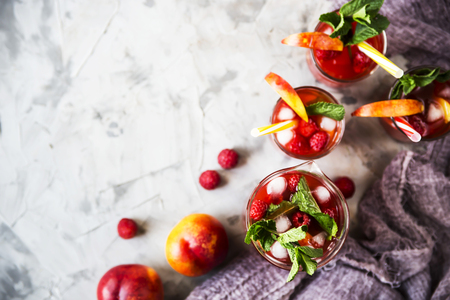 Light summer refreshing drink with fruits and berries - sangria. In glasses on a gray table Top view, flat lay, Copyspaceの写真素材