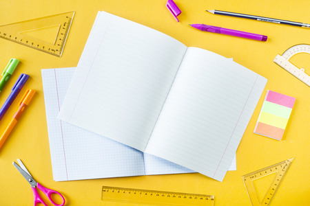 Writing-books, pens, pencils and rulers on a yellow background. Accessories for study. Top view, flat layの写真素材