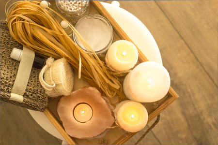 Ecological accessories for a spa in a home bathroom on a wooden tray with candles. Eco accessories. Top view, flat layの写真素材