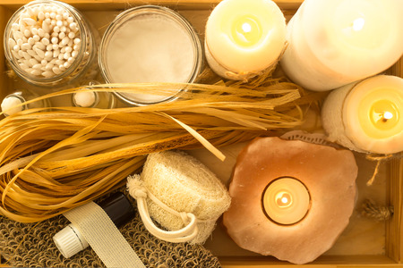Ecological accessories for a spa in a home bathroom on a wooden tray with candles. Eco accessories. Top view, flat layの写真素材