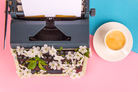 Typewriter with white flowers from the keys - spring writing creativity on the concept. On a bright pink background. Top view, flat layの写真素材