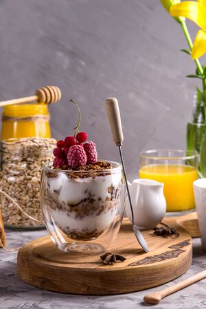 Dessert with granola and yogurt in glasses with double glass for breakfastの写真素材