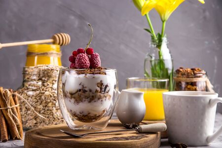Dessert with granola and yogurt in glasses with double glass for breakfastの写真素材