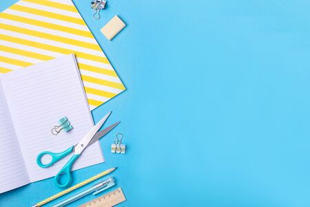 Bright modern minimalist stationery for school studies on a blue background. Back to school concept. Top view, flat layの写真素材