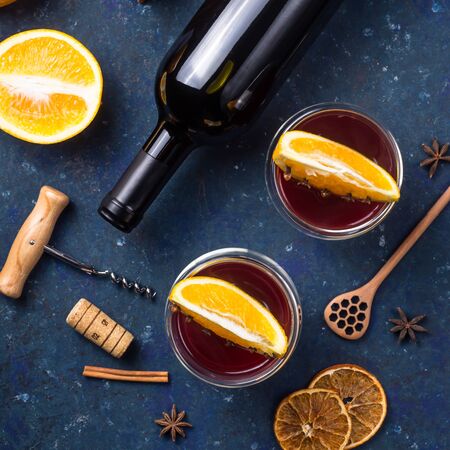 Two glasses of hot clint wine with slices of orange among the ingredients for cooking and a bottle of wine. Top viewの写真素材