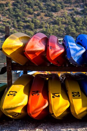 Active kayaking by the sea among the mountains. Colored boat parkingの写真素材