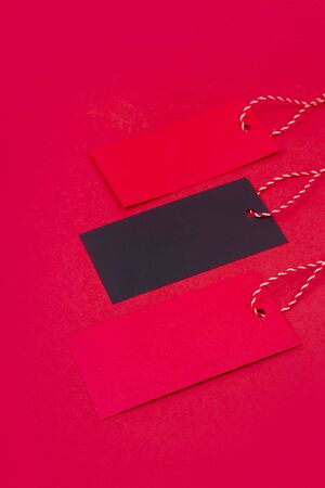 Red and black labels with items bought in stores on black friday. The concept of discounts and gifts. Top view.の写真素材