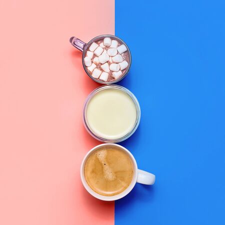 Classic blue and living coral with different types of hot drinks - coffee, matcha, cocoa and white creamers with milk and cream. Color of the year 2020.の写真素材